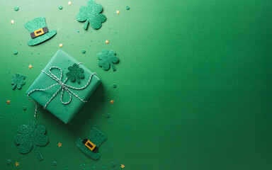 Wall Mural - Happy St Patrick's Day decoration concept made from shamrocks ( clover leaf), gift box and leprechaun hat on green background.
