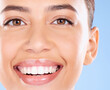 © Emily N/peopleimages.com - Teeth, dental and face portrait of woman with clean smile, teeth whitening and oral self care on blue background. Tooth implant, healthcare and beauty model with makeup, cosmetics and facial skincare