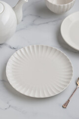 Empty tableware - white plate a bowl and a cup on white table as a background for a dish foodbackground