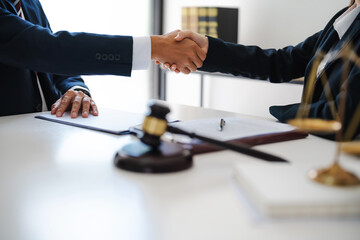 Wall Mural - Lawyer consultant shaking hand with client sign contract agreement document. in law firm. Business meeting Handshake.  