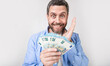 photo of glad man with cash money. man with cash money isolated on studio background.