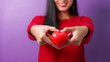 © NanSan - Portrait of pretty asia cheerful lady arms hold heart ball toothy smile isolated on violet color background, for valentine day color tone