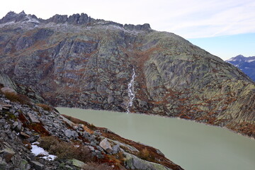 View on a lake in the Grimsel Pass which is a mountain pass in Switzerland, crossing the Bernese Alps at an elevation of 2,164 metres