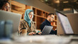 © Gorodenkoff - Portrait of Focused Muslim Woman Using Laptop in a Contemporary Spacious Office. Account Specialist Smiling While Having Productive Day. Active Colleagues Working on Computers in the Background.