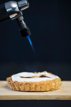 A Blow Torch Browning The Top Of A Meringue Tart