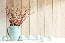 Easter Eggs And Vase With First Willow Flowers On White Table