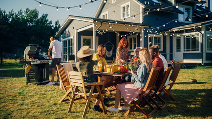 Wall Mural - Parents, Children and Friends Gathered at a Barbecue Dinner Table Outside a Beautiful Home. Old and Young People Have Fun, Eat and Drink. Garden Party Celebration in a Backyard.