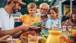 © Gorodenkoff - Young Boy Picking Up a Bowl of a Tasty Vegetarian Salad with Leaves and Cherry Tomatoes. Son Putting Vegan Food on a Plate to His Father. Garden Dinner with Family.