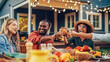 © Gorodenkoff - Family and Multiethnic Diverse Friends Gathering Together at a Garden Table Dinner. Old and Young People Toasting and Clinking Glasses with Fresh Orange Juice and Celebrating an Event.