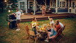 © Gorodenkoff - Big Family Garden Barbecue Party Celebration, Gathered Together at a Table with Relatives and Friends. Young and Senior People are Eating, Drinking, Passing Dishes, Joking and Having Fun.