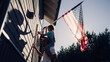 © Gorodenkoff - Cinematic Shot of a Father Holding His Small Daughter of His Shoulders, Helping Her to Raise the United States of America Flag to Celebrate a National Fourth of July Holiday at Their House.
