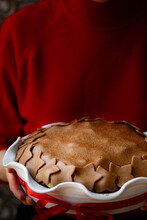 Christmas Pie Held By A Woman In A Red Top