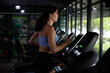 © offsuperphoto - young sports woman working out and running on treadmill in gym