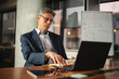 © JustLife - Businessman on video call. Handsome man in office using laptop.