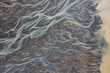 © AmazingAerialAgency - Aerial view of abstract water formation from a river estuary at Holtsos lake along the coast, Iceland.