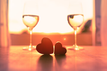 Sticker - Valentine's romantic date night background. Two glasses of champagne and a pair of hearts. 