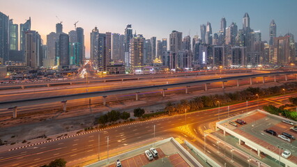 Wall Mural - Dubai marina tallest block of skyscrapers day to night timelapse.