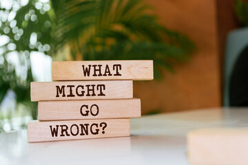 Poster - Wooden blocks with words 'WHAT MIGHT GO WRONG?'.