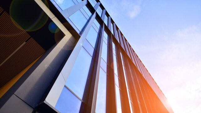 glass modern building with blue sky background. low angle view and architecture details. urban abstr