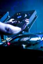 Close Up Of A DJ's Hands Performing At A Rave Party.