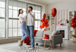 © Pixel-Shot - Happy couple in love dancing at home on Valentine's Day
