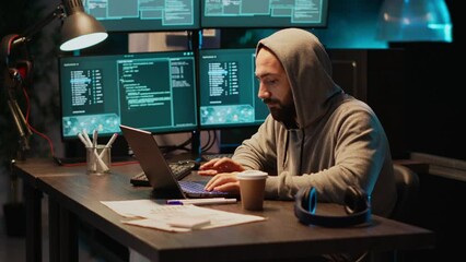 Hacker programmer coding system late at night, using virus to produce computer malware and error. Data developer stealing information from software app, working with multiple monitors.