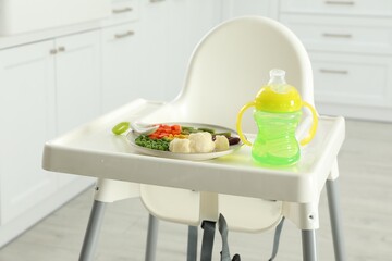 Sticker - Baby high chair with healthy food and water indoors