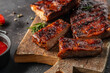 Barbecue chuck beef ribs with hot rub sliced on a wooden cutting board, Food recipe background. Close up