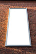 Vertical blank billboard on a brick wall