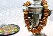 Traditional Russian samovar with a bunch of bagels in white, light room