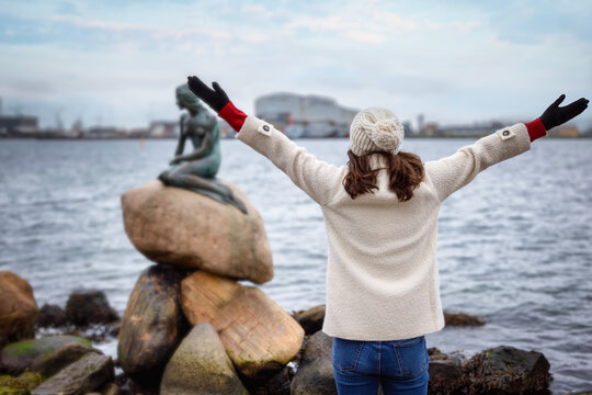 a happy tourist woman explores the famous sights of copenhagen in denmark during winter time