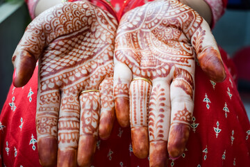 Beautiful woman dressed up as Indian tradition with henna mehndi design on her both hands to celebrate big festival of Karwa Chauth, Karwa Chauth celebrations by Indian woman for her husband