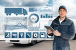 © scharfsinn86 - Manager with a digital tablet next to trucks. Fleet management