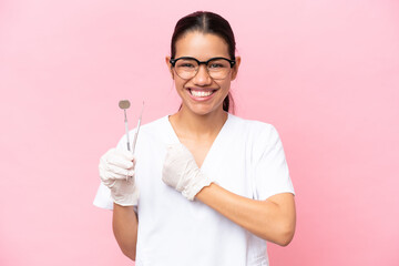 Wall Mural - Dentist Colombian woman isolated on pink background celebrating a victory