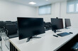 © Alexander Kladov - Modern high-tech office with desktop PCs and computer monitors for video conferencing via Internet, remote meetings and presentations
