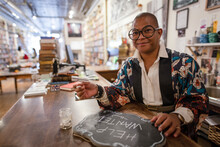 Portrait Smiling Business Owner Writing Help Wanted Sign In Bookshop