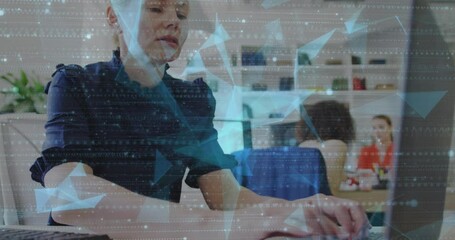 Wall Mural - Animation of particles and geometric shapes over caucasian woman working over laptop at office