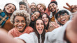 © Davide Angelini - Multicultural community of young people smiling together at camera - Happy diverse friends taking selfie picture with smart mobile phone device - Friendship and human relationship concept