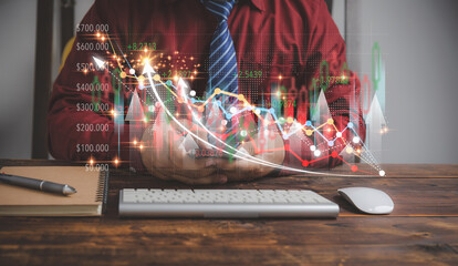 Businessman use smartphones to check stock online with virtual screens on a growth graph stock chart. Investment, business, technology concept. Virtual screen with growth graph, and stock chart.