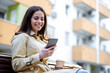 © ivanko80 - Woman sitting on bench and using smart phone