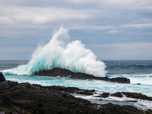 Wave Breaking Onto Rocks.