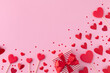 Saint Valentine day background with gift box and various red hearts. Flat lay style greeting composition.