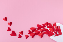 Creative Composition On Saint Valentine Day. Envelope And Paper Red Hearts For Love Message On Pink Background. .