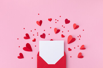 saint valentine day holiday background with envelope, paper card and various red hearts for love rom