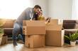 © ivanko80 - Smiling couple unpacking boxes in new home
