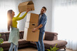 © ivanko80 - Smiling couple unpacking boxes in new home