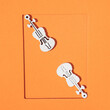 two violins on an orange background