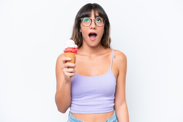 Canvas Print - Young caucasian woman with a cornet ice cream over isolated white background looking up and with surprised expression