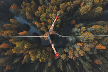 Highline Over The Forest. Rope Walker Walks On A Rope At High Altitude. Drone View. Slackline Theme