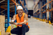 © Dusan Petkovic - A distribution center worker is inventorying on tablet and giving thumbs up while smiling at the camera.